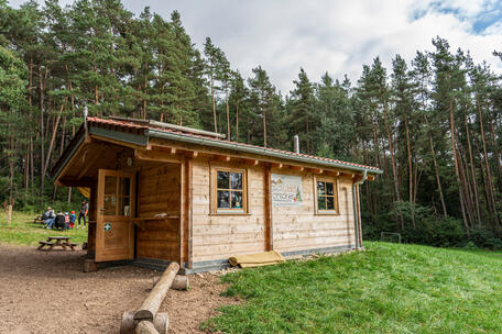 The forest cabin as the heart of the facility.